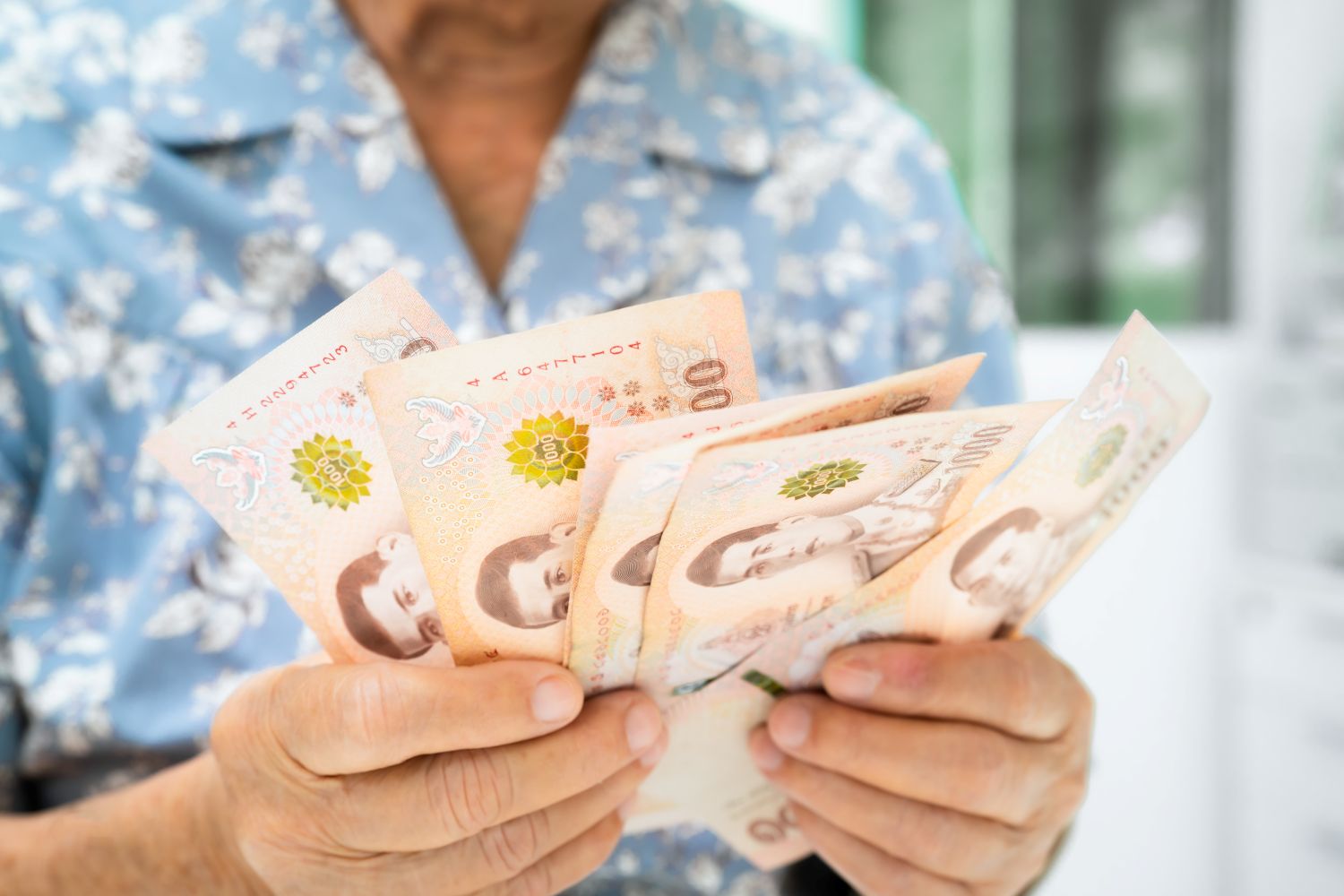 woman holding cash after winning the lottery